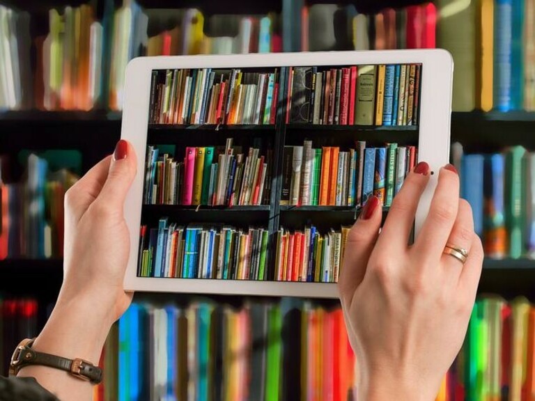 Colourful collection of books viewed through a tablet