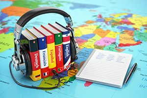 Books and headphones on the map world.